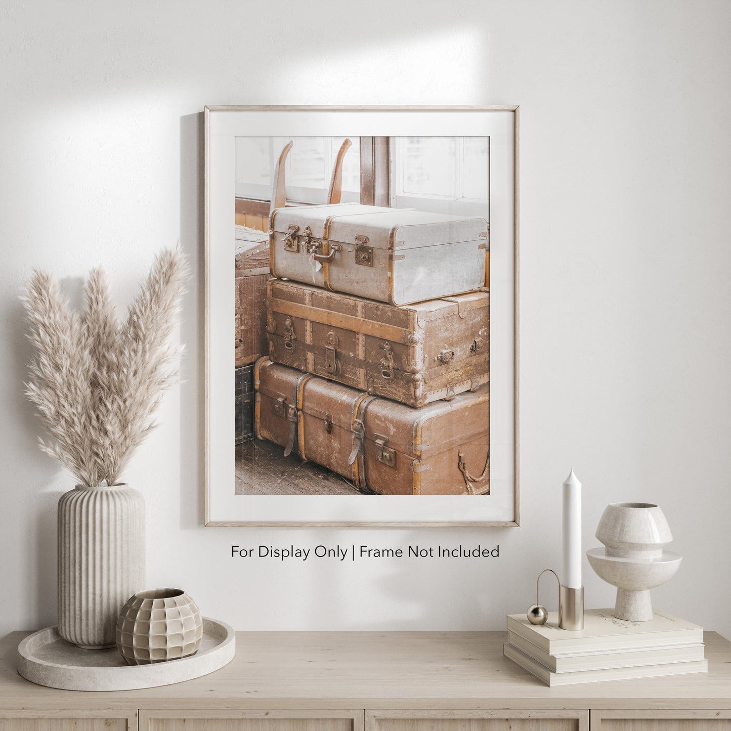 Stack of vintage suitcases and trunks with worn leather and metal details, photographed in soft natural light for a warm, rustic aesthetic.