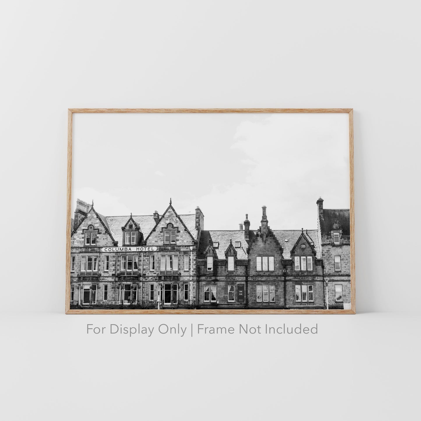 Black and white photograph of the historic Columba Hotel building in Inverness, Scotland, with stone architecture and gabled rooftops.