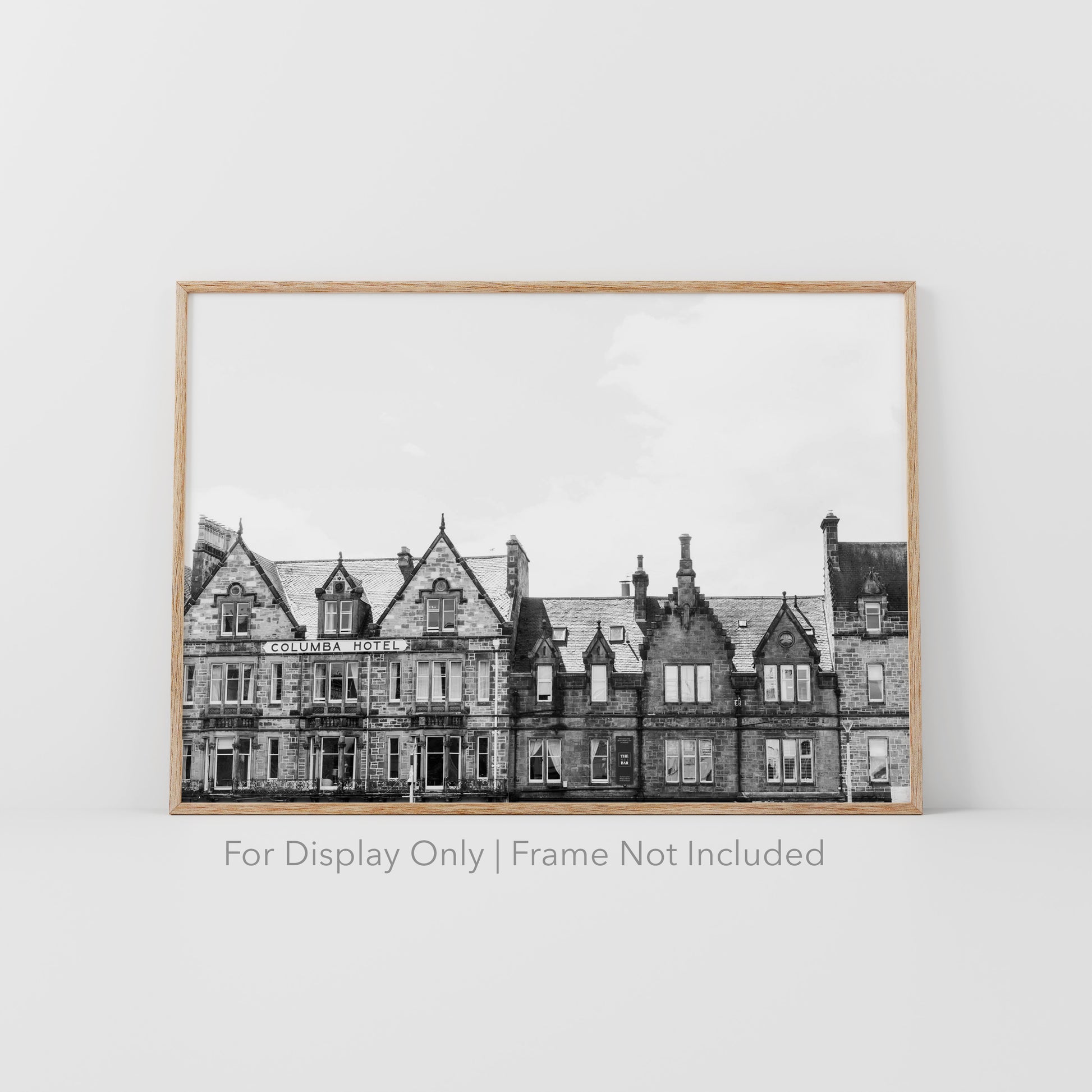 Black and white photograph of the historic Columba Hotel building in Inverness, Scotland, with stone architecture and gabled rooftops.