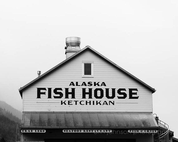 Black and white photograph of the Alaska Fish House in Ketchikan, displayed as a print with a text overlay.