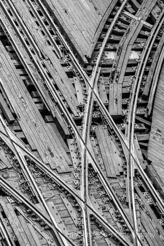a black and white photo of train tracks
