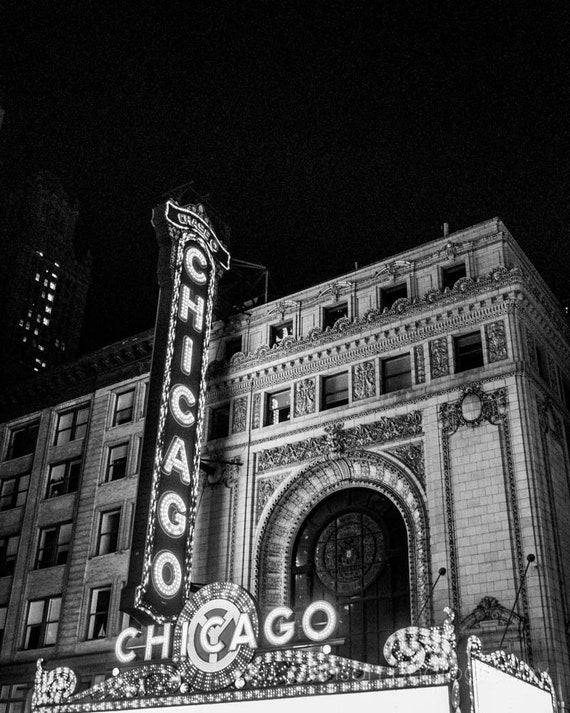 A black and white photograph of a Chicago marquee sign at night.