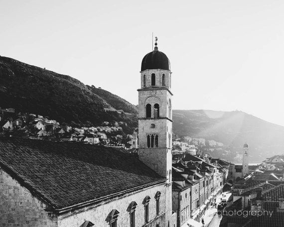 a black and white photo of a church tower