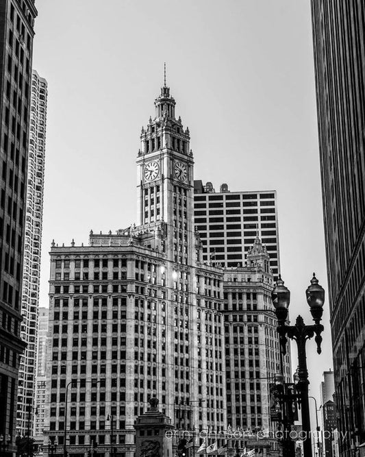 a black and white photo of a clock tower in a city