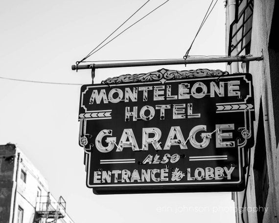 a black and white photo of a sign for a hotel