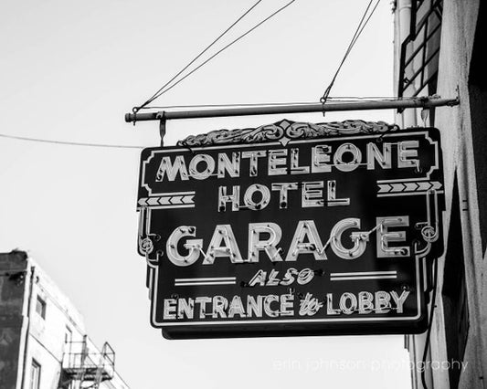 a black and white photo of a sign for a hotel
