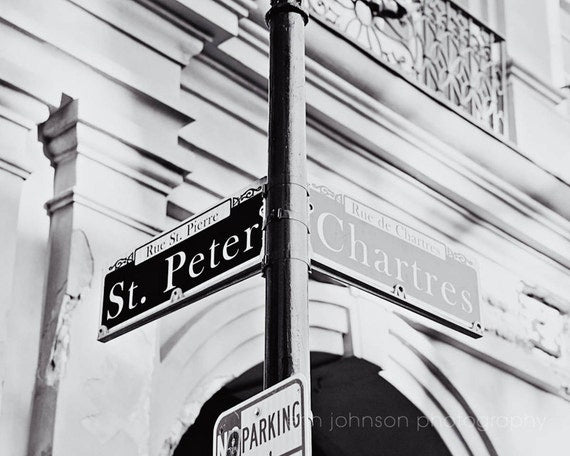 Black and white photograph of St Peter Street and Chartres Street signs in New Orleans, Lousiana.