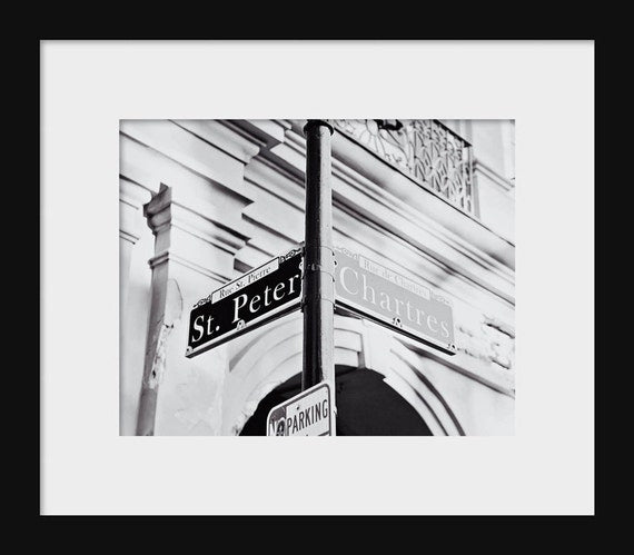 Black and white photograph of St Peter Street and Chartres Street signs in New Orleans, Lousiana.