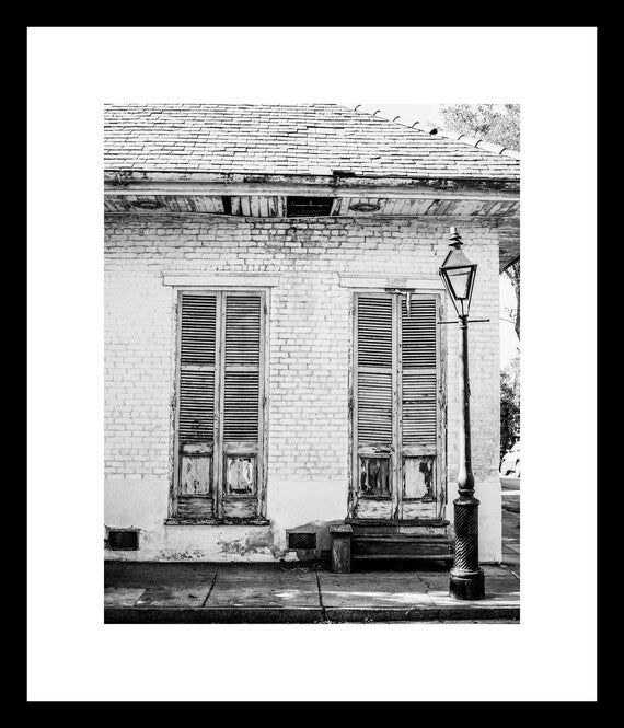Black and white New Orleans photography print of French Quarter doors and shutters, rustic architectural wall art
