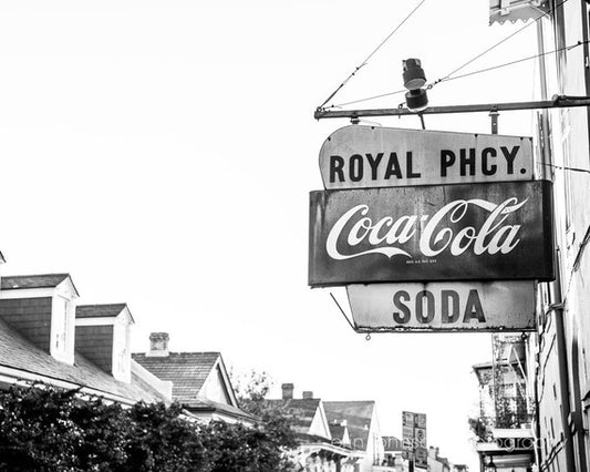 a black and white photo of a royal phcy soda sign