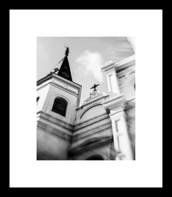 Black and white photograph of St. Louis Cathedral in Jackson Square, New Orleans, with a focus on architectural details.