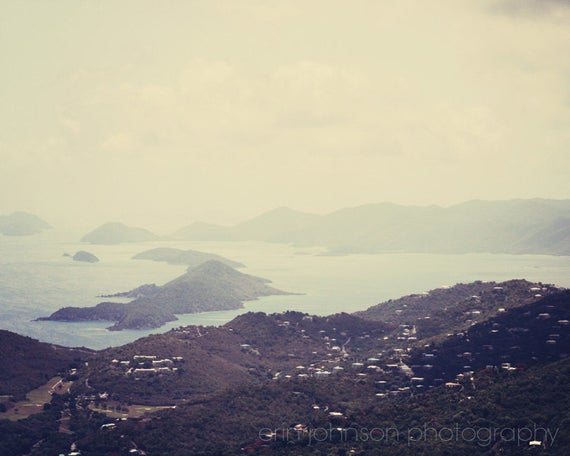 a scenic view of a small town and a body of water