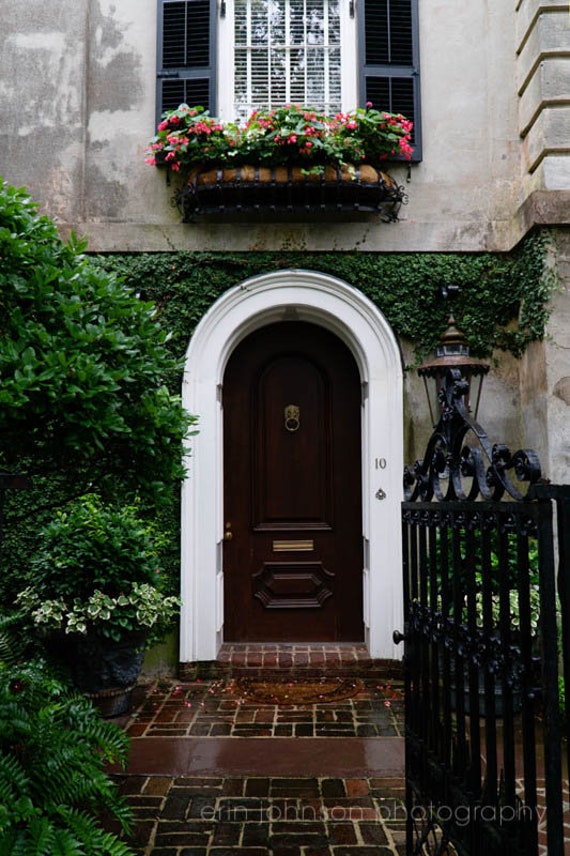 a house with a brown door and a black gate