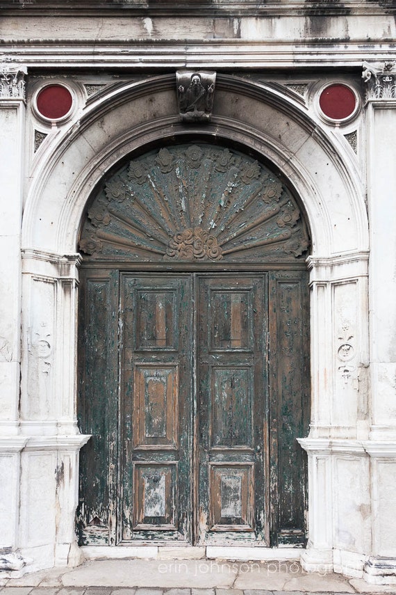 a large wooden door with a clock on it's side