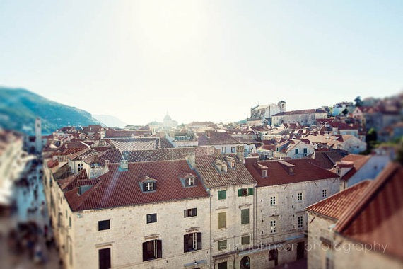 Panoramic photograph of Dubrovnik Old Town rooftops with orange tile roofs and historic architecture, perfect as travel themed wall art, framed wall print, or canvas wall art decor.
