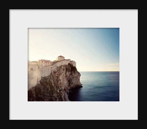 A photograph of Dubrovnik, Croatia, showing the old town wall and the sea in the background.