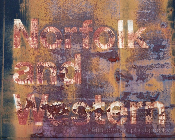 A high-resolution photograph of a rusted Norfolk and Western train with distressed typography in the background, printed on archival-quality paper.