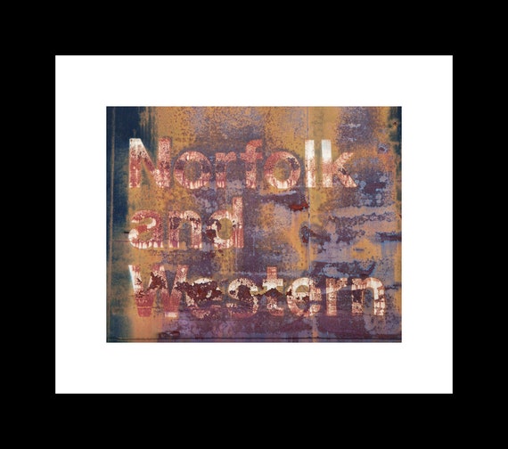 A high-resolution photograph of a rusted Norfolk and Western train with distressed typography in the background, printed on archival-quality paper.