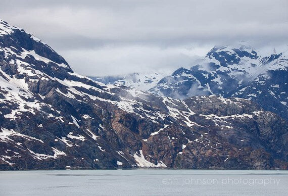 a mountain range with snow covered mountains in the background