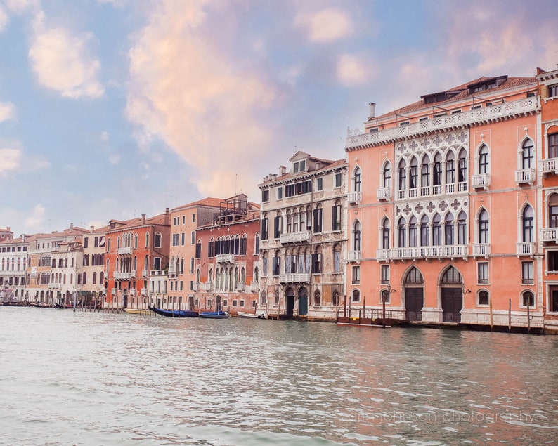 a row of buildings next to a body of water
