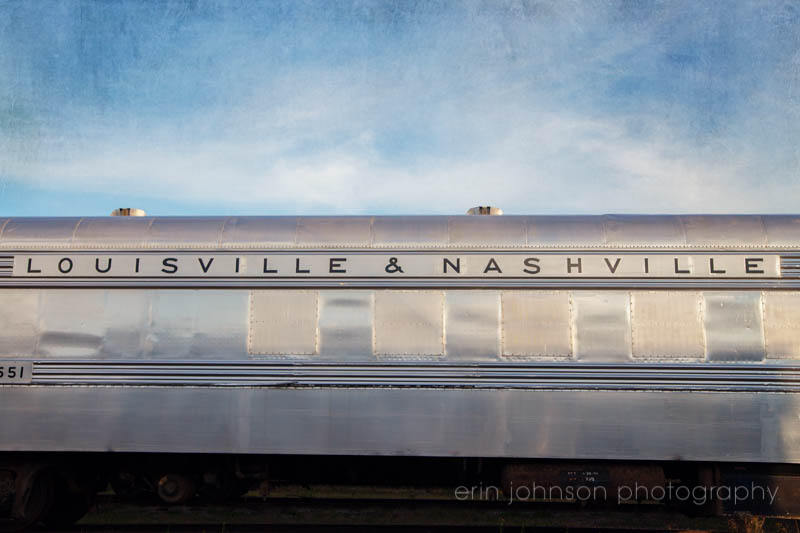 Photograph of the Louisville and Nashville train under a blue sky, perfect for industrial wall art and travel-inspired home décor.
