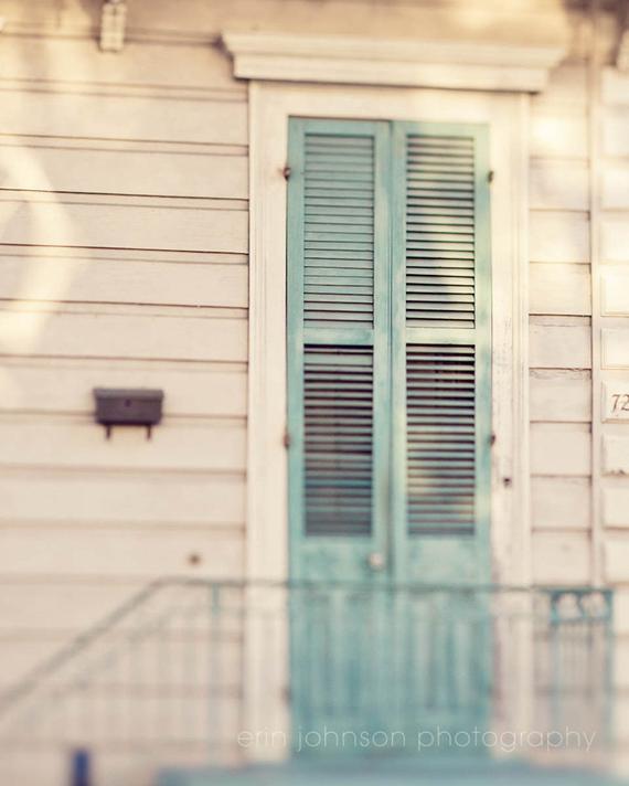 Blue shutter door in the French Quarter of New Orleans, architectural photography capturing vibrant local charm, ideal for wall art and home décor.