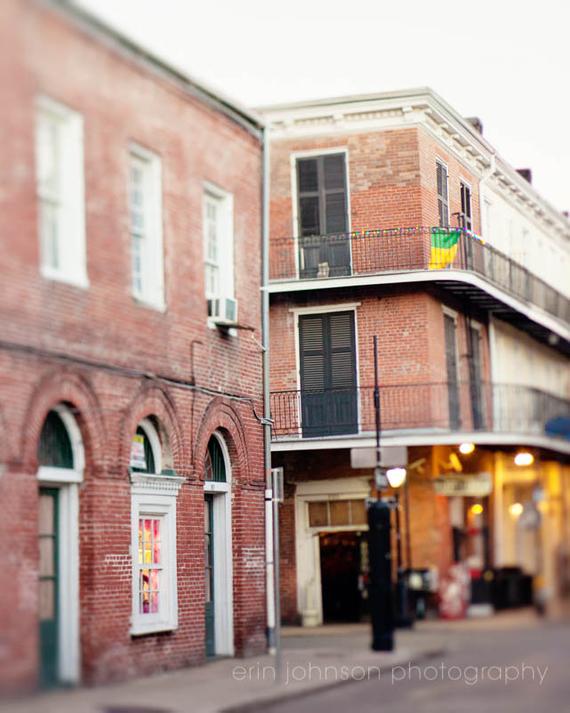 A photograph featuring a French Quarter street scene with buildings on either side of the street.