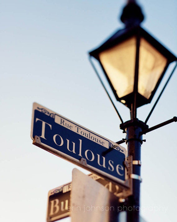 a street light with street signs attached to it