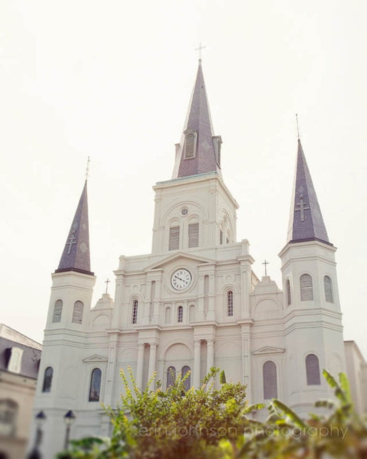 a large white building with a clock on it's side