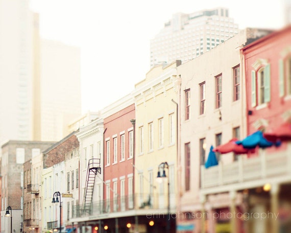 A photograph featuring a street in the French Quarter with colorful buildings.