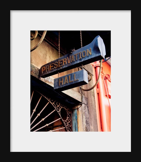 A color photograph of a 'Preservation Hall' sign in New Orleans, Louisiana