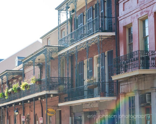 a row of buildings with a rainbow in the background