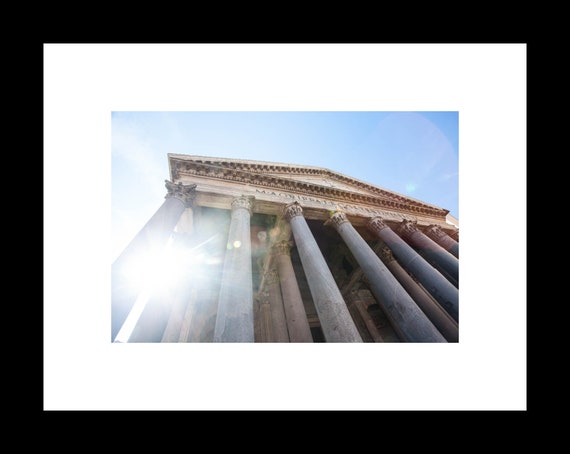 The Pantheon in Rome bathed in sunlight showing columns and portico