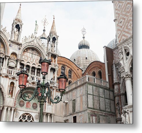 A metal print featuring the St Marks Basilica in Venice, Italy, with a focus on its architectural details and colorful facade.