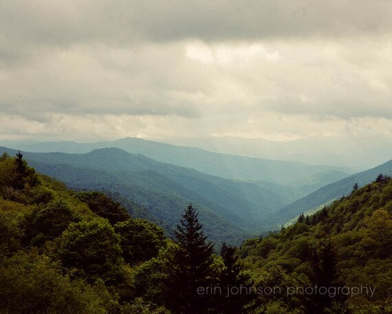 a scenic view of a mountain range in the distance