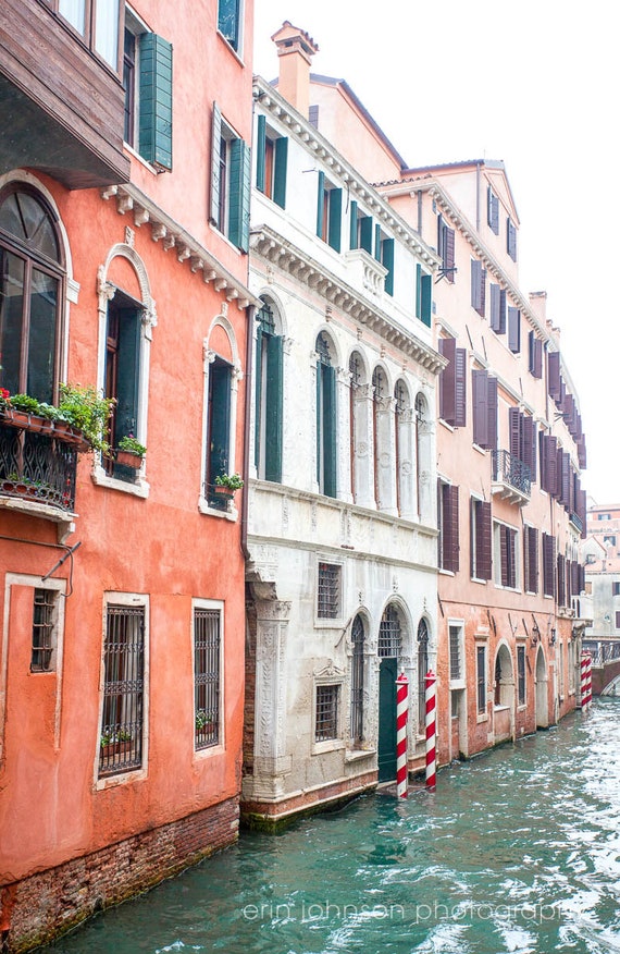 a canal with buildings and a boat in the water
