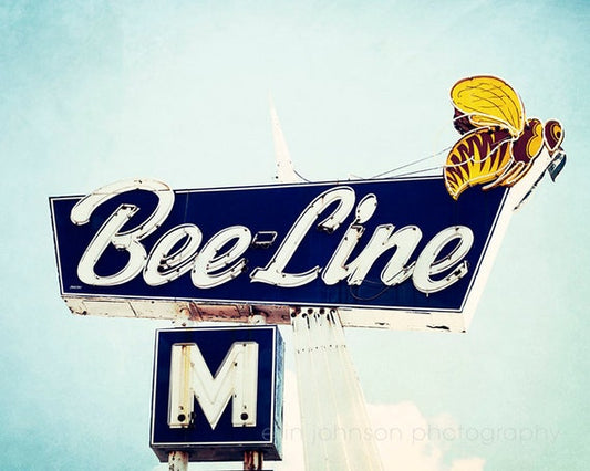 Photograph of the Bee Line motel sign in Dothan, Alabama with a blue sky behind.