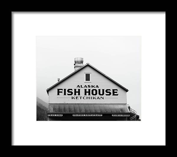 a black and white photo of a fish house