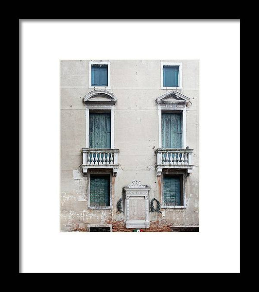 a building with two balconies and a door