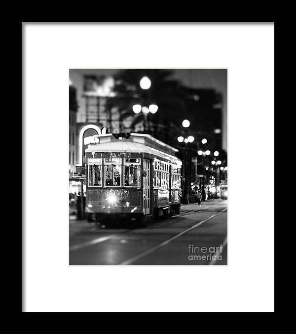 a black and white photo of a trolley on a street