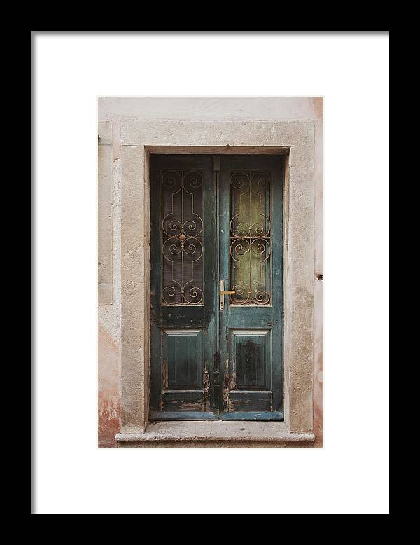 a green door with iron bars on it