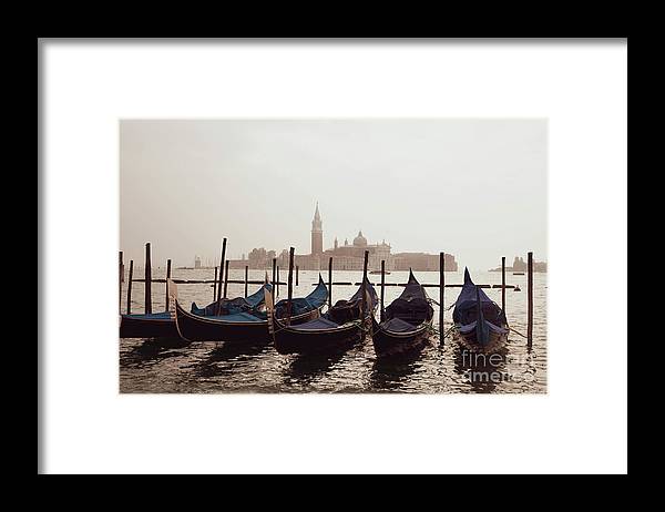 a row of gondolas sitting on top of a body of water