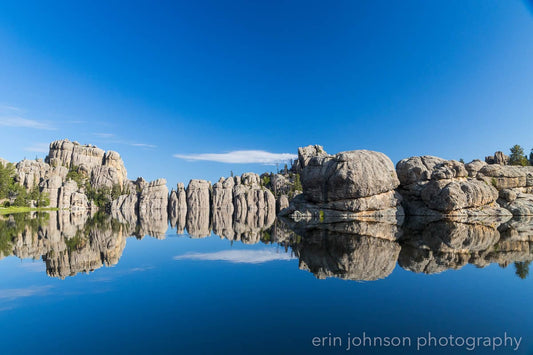 a body of water surrounded by rocks and trees