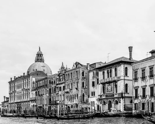 Black and white photograph of the Grand Canal in Venice, Italy, featuring architectural details of the city's buildings.