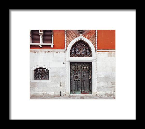 a black and white photo of a door and windows