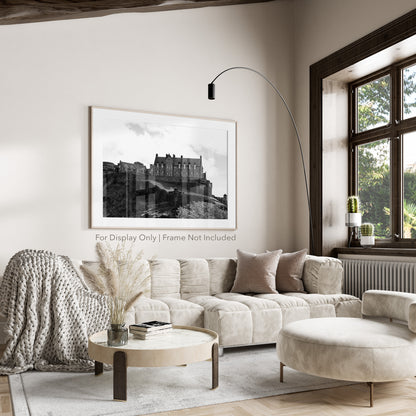 Black-and-white photograph of Edinburgh Castle perched on Castle Rock in Scotland, with dramatic stone walls and historic architecture.