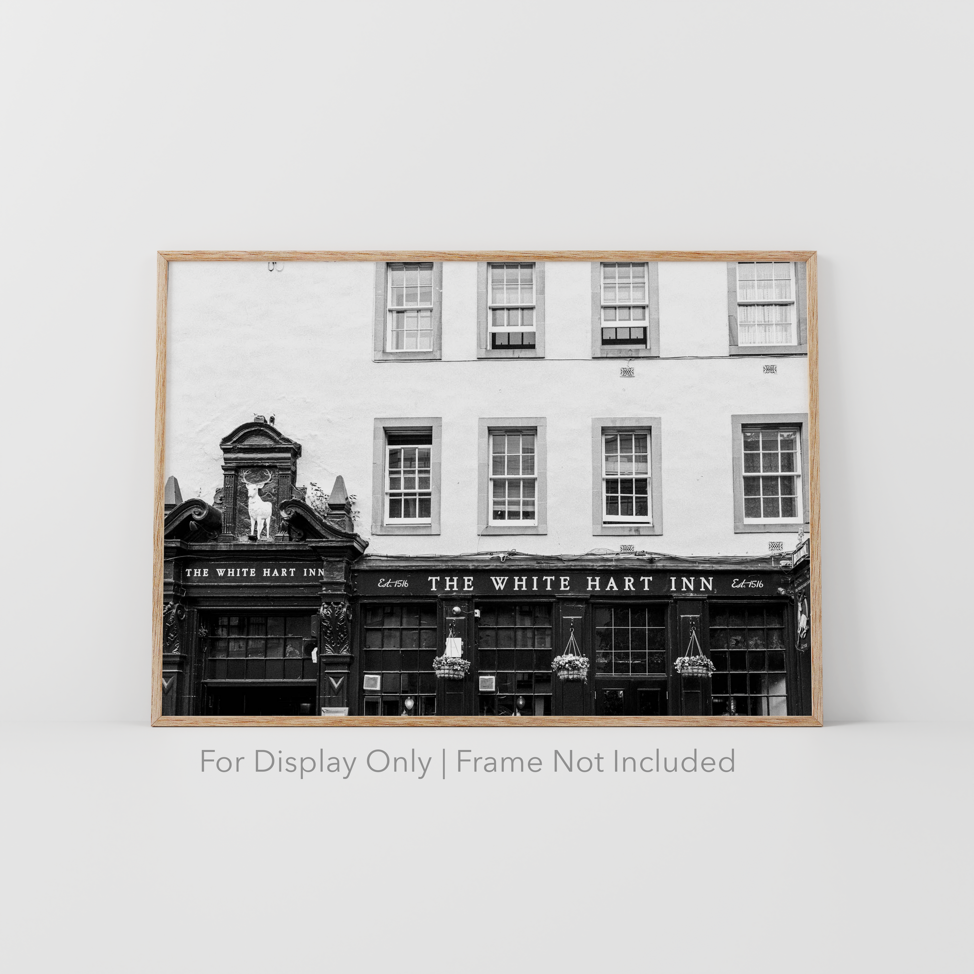 Black and white photograph of The White Hart Inn in Edinburgh Scotland featuring historic pub architecture and vintage signage.