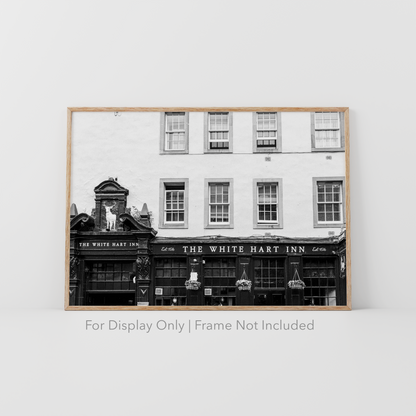 Black and white photograph of The White Hart Inn in Edinburgh Scotland featuring historic pub architecture and vintage signage.