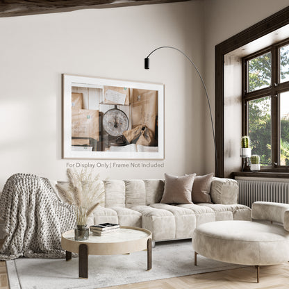Rustic still life of vintage parcels wrapped in brown paper with stamps, stacked around a weathered post office scale.