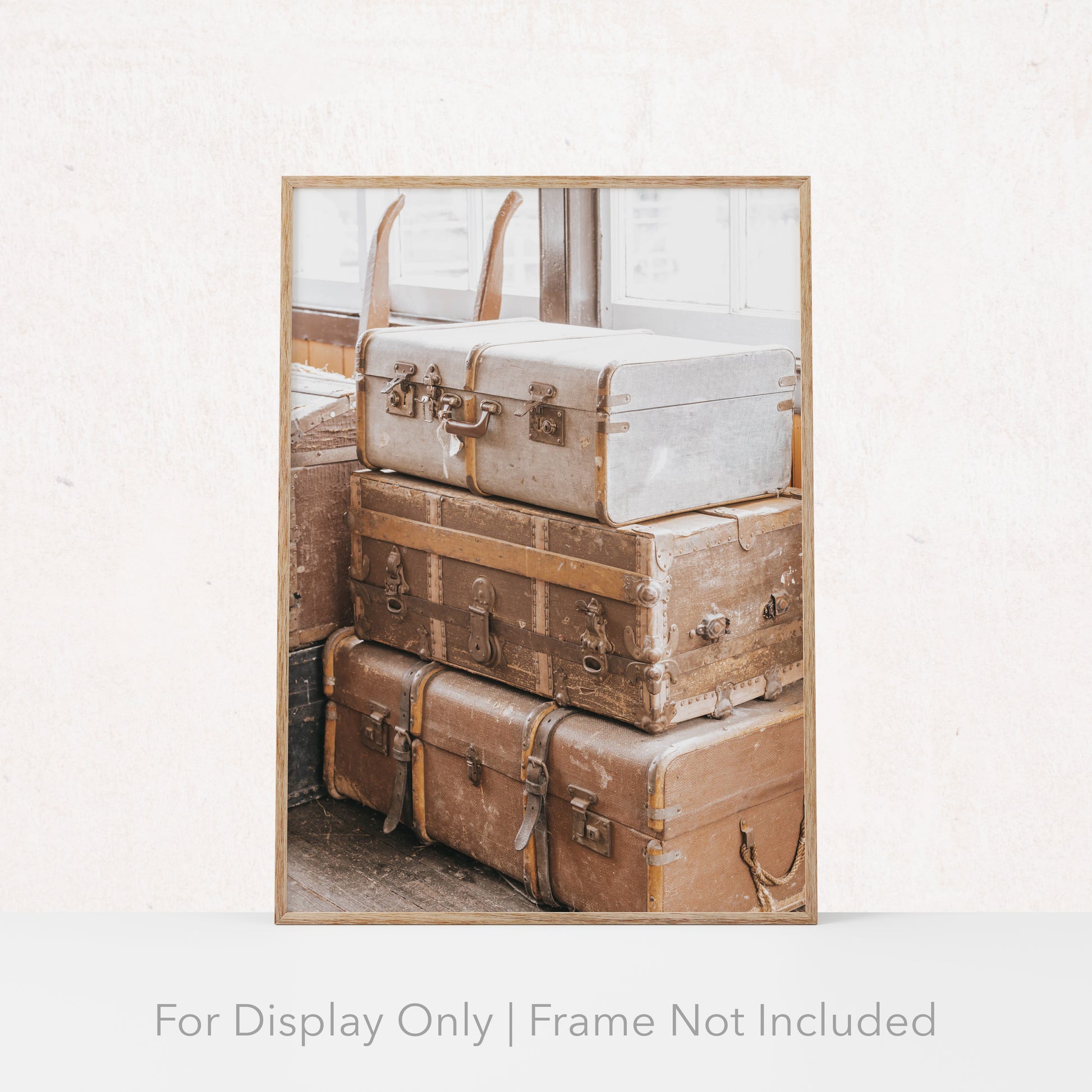 Stack of vintage suitcases and trunks with worn leather and metal details, photographed in soft natural light for a warm, rustic aesthetic.